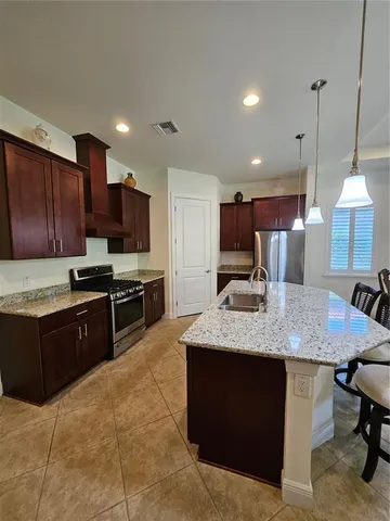 a kitchen with stainless steel appliances granite countertop a sink counter space cabinets and a counter top space