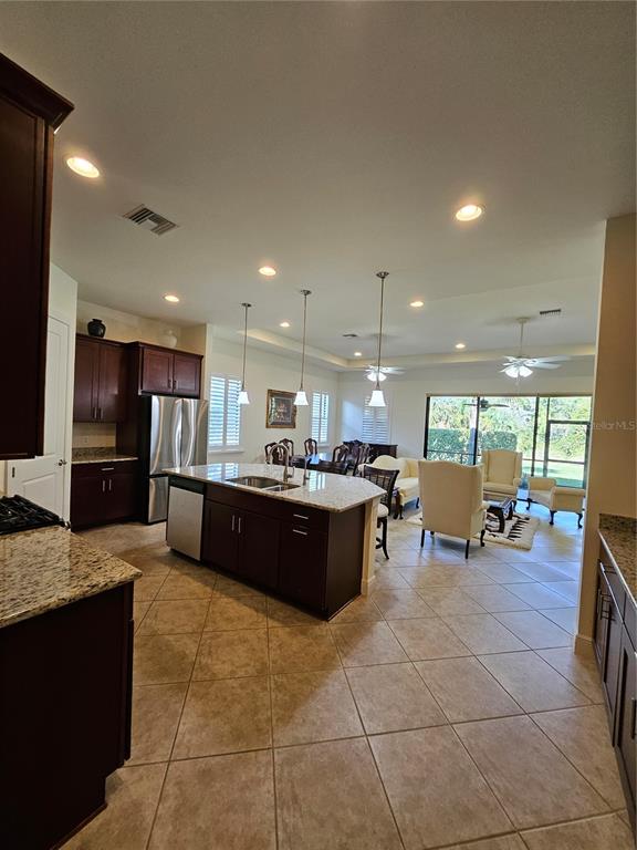 1283 Manado Drive Naples, FL 34113 - Photo 6 of 48 a large kitchen with a large counter top furniture and appliances