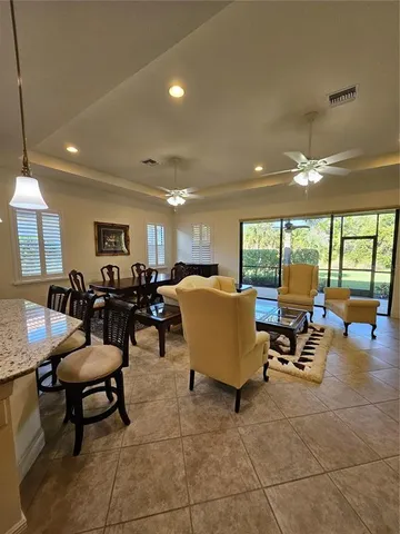 a living room with lots of chairs and a table