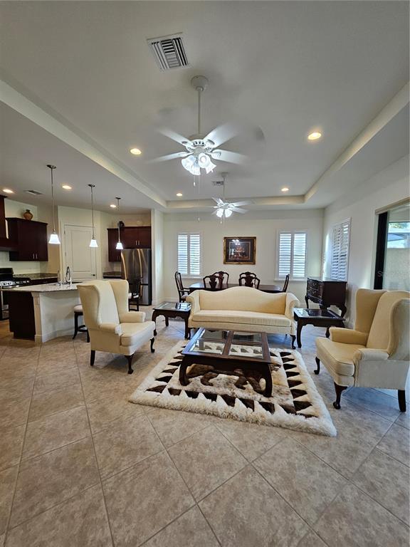 1283 Manado Drive Naples, FL 34113 - Photo 8 of 48 a living room with furniture kitchen and a chandelier