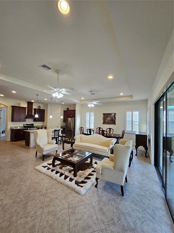 1283 Manado Drive Naples, FL 34113 - Photo 10 of 48 a living room with furniture and kitchen view