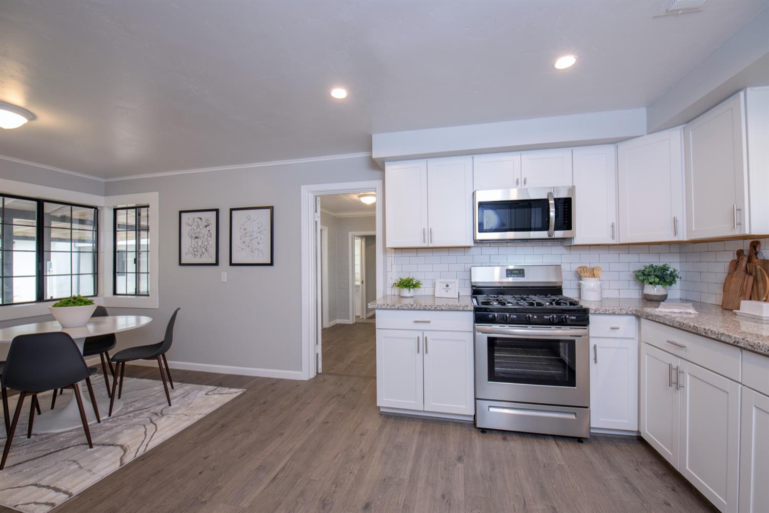 1322 North Reed Avenue Reedley, CA 93654 - Photo 15 of 54 a kitchen with a stove a sink and a refrigerator