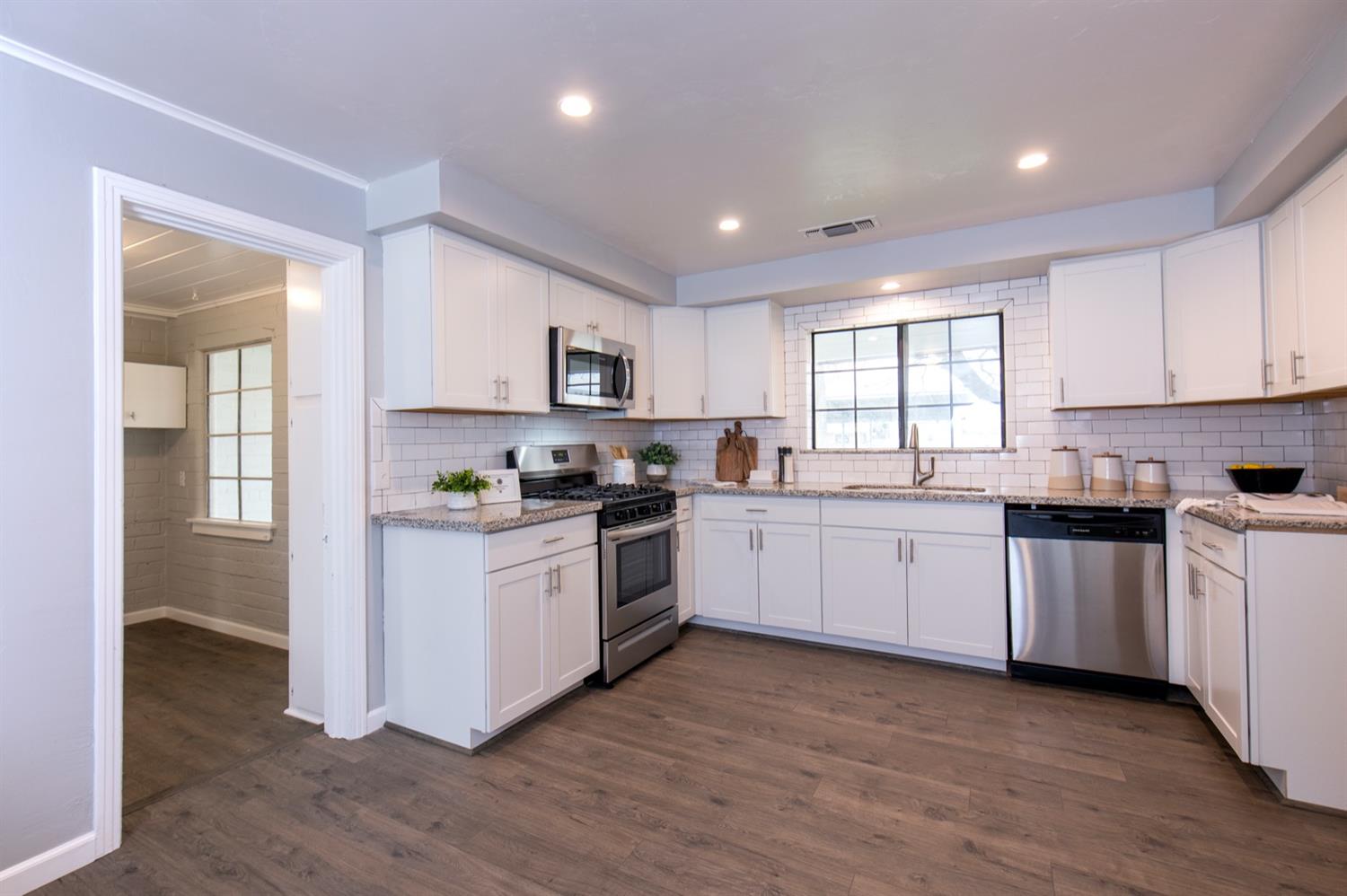 1322 North Reed Avenue Reedley, CA 93654 - Photo 18 of 54 a kitchen with sink a microwave and cabinets