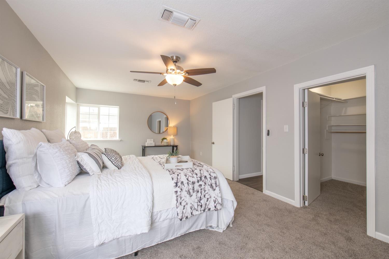 1322 North Reed Avenue Reedley, CA 93654 - Photo 22 of 54 a bedroom with a large bed and a chandelier