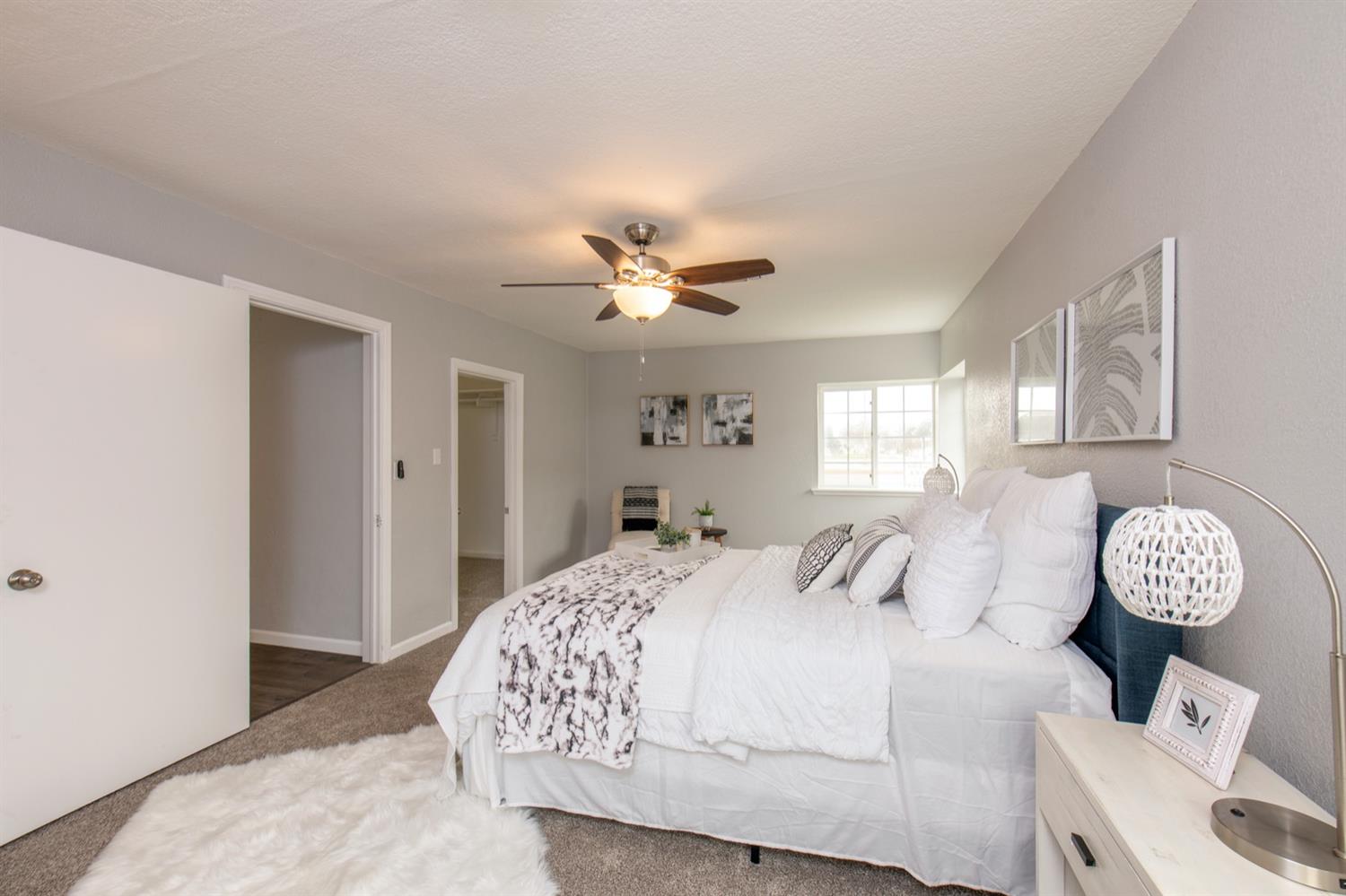 1322 North Reed Avenue Reedley, CA 93654 - Photo 23 of 54 a bedroom with a bed chandelier and a window