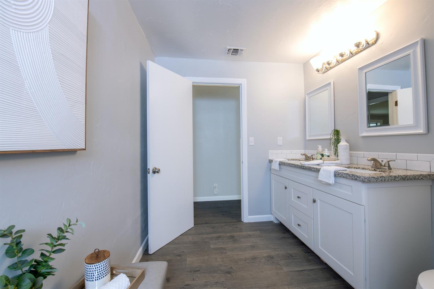 1322 North Reed Avenue Reedley, CA 93654 - Photo 25 of 54 a bathroom with a granite countertop sink and a mirror