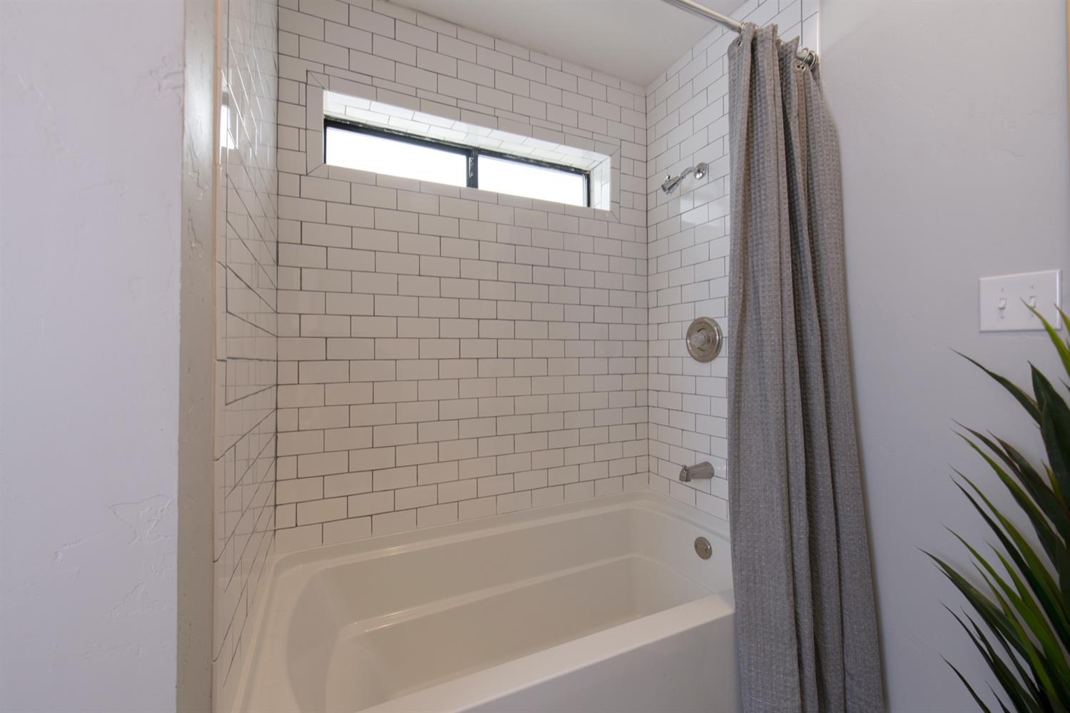 1322 North Reed Avenue Reedley, CA 93654 - Photo 26 of 54 a bathroom with a bathtub