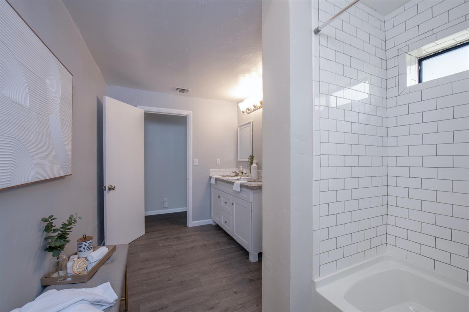 1322 North Reed Avenue Reedley, CA 93654 - Photo 27 of 54 a bathroom with a tub sink and mirror