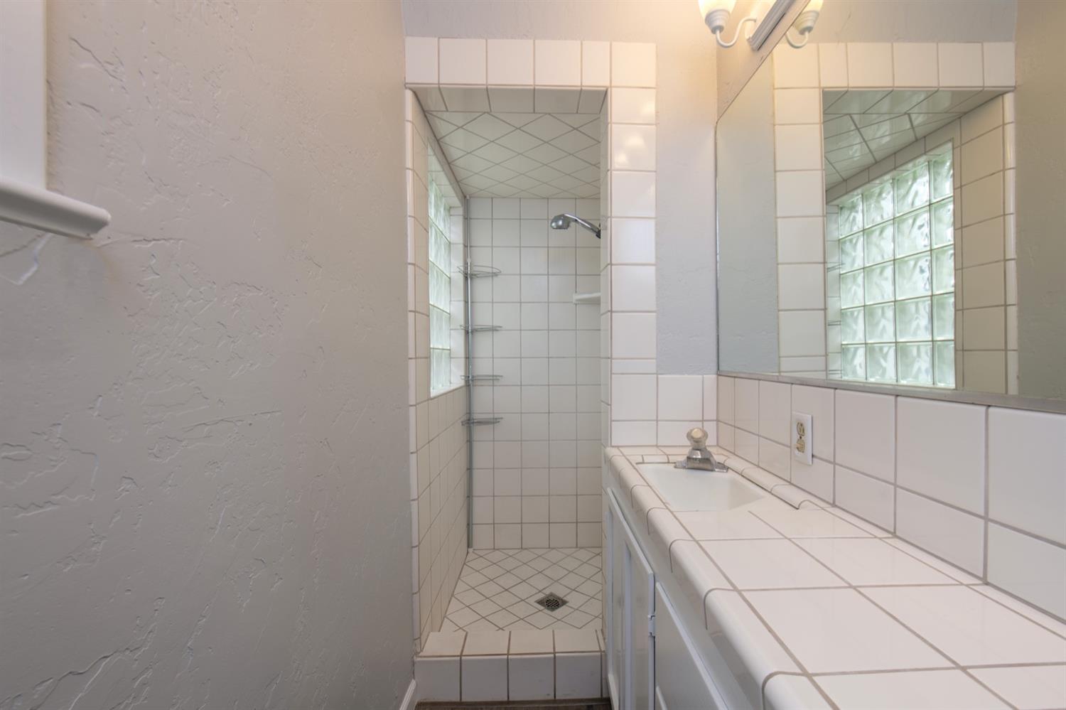 1322 North Reed Avenue Reedley, CA 93654 - Photo 34 of 54 a bathroom with a bathtub and shower