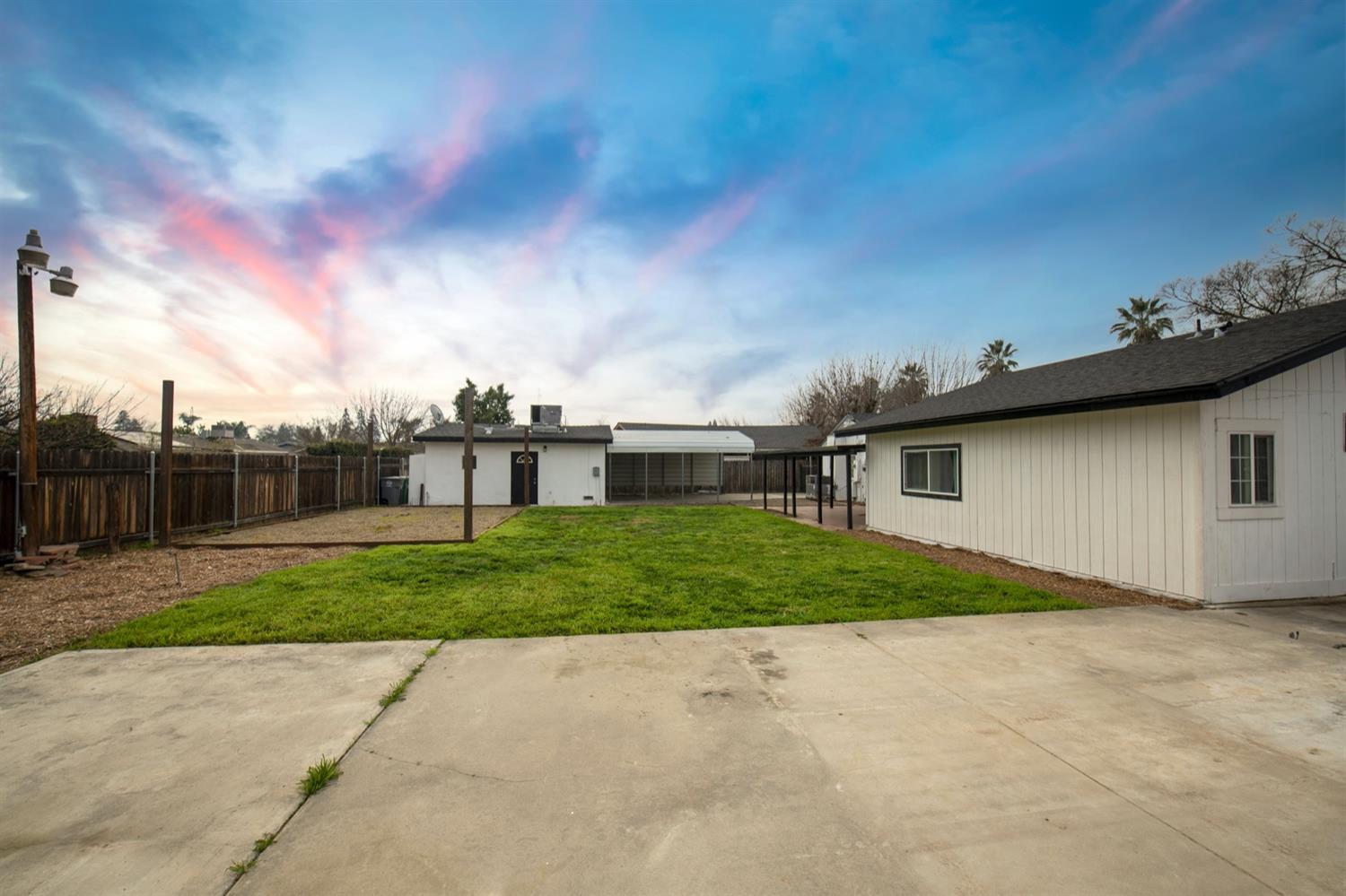1322 North Reed Avenue Reedley, CA 93654 - Photo 43 of 54 a view of a yard in front of a house with a large tree