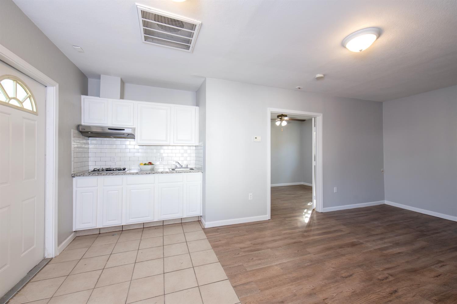 1322 North Reed Avenue Reedley, CA 93654 - Photo 46 of 54 a kitchen with a sink cabinets and wooden floor