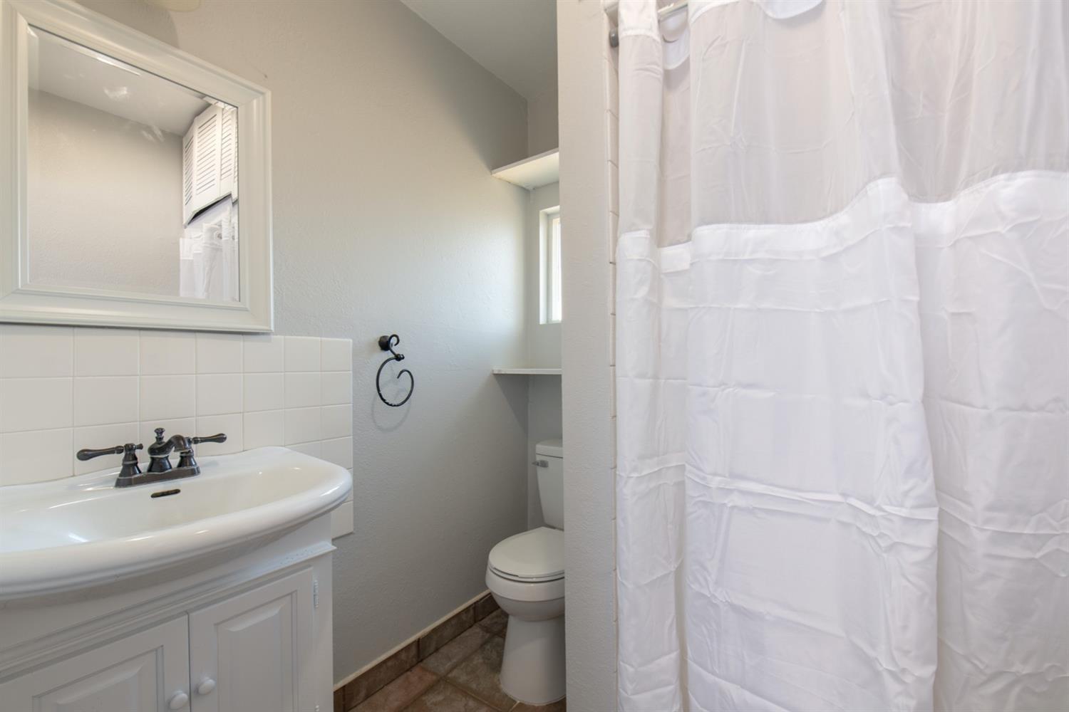 1322 North Reed Avenue Reedley, CA 93654 - Photo 49 of 54 a bathroom with a sink a toilet and shower