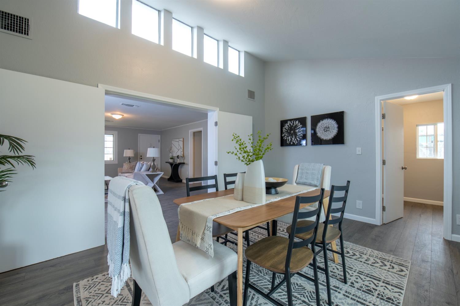 1322 North Reed Avenue Reedley, CA 93654 - Photo 10 of 54 a view of a dining room with furniture and wooden floor