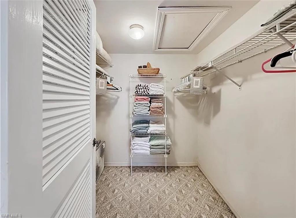 905 Augusta Boulevard Naples, FL 34113 - Photo 17 of 20 a view of a hallway with stairs and a large window