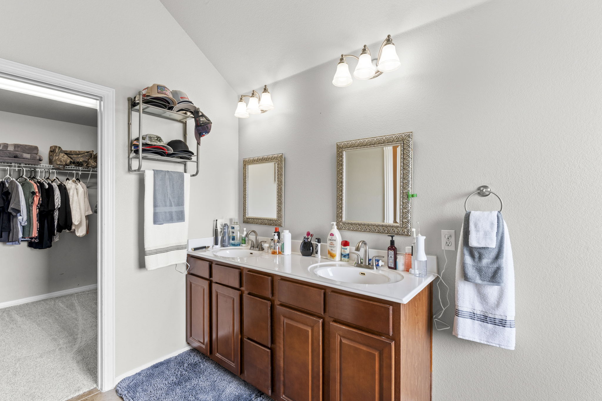 227 Sandstone Trail Buda, TX 78610 - Photo 13 of 33 Dual vanity with wood-finish cabinetry, white countertops, and individual framed mirrors