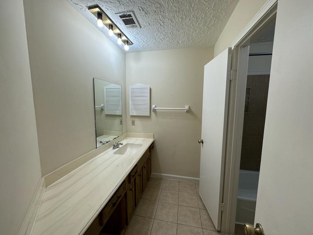 239 Kings Way Stafford, TX 77477 - Photo 17 of 24 a bathroom with a sink a vanity and a mirror