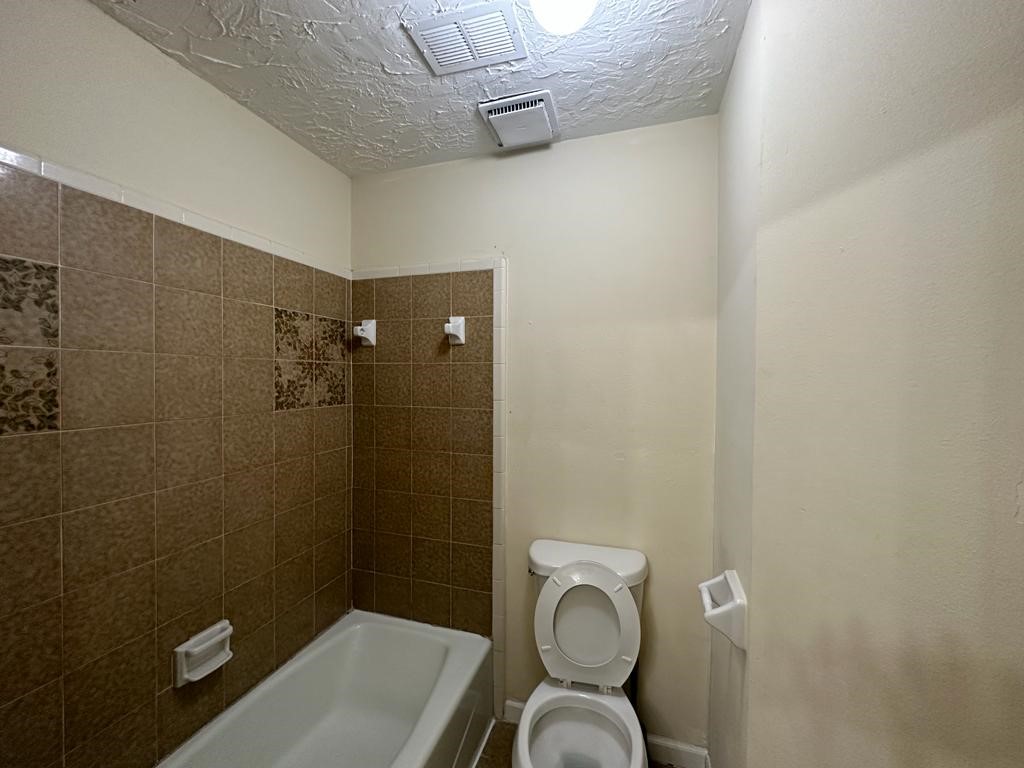 239 Kings Way Stafford, TX 77477 - Photo 18 of 24 a bathroom with a toilet and a shower