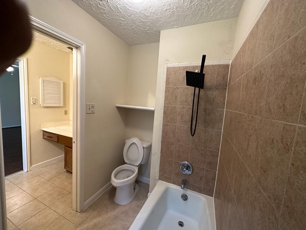 239 Kings Way Stafford, TX 77477 - Photo 20 of 24 a bathroom with a toilet and a shower