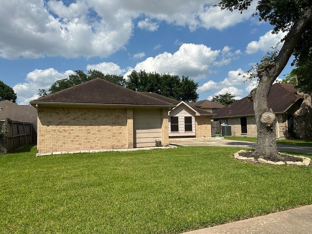 239 Kings Way Stafford, TX 77477 - Photo 24 of 24 a front view of a house with a garden and yard