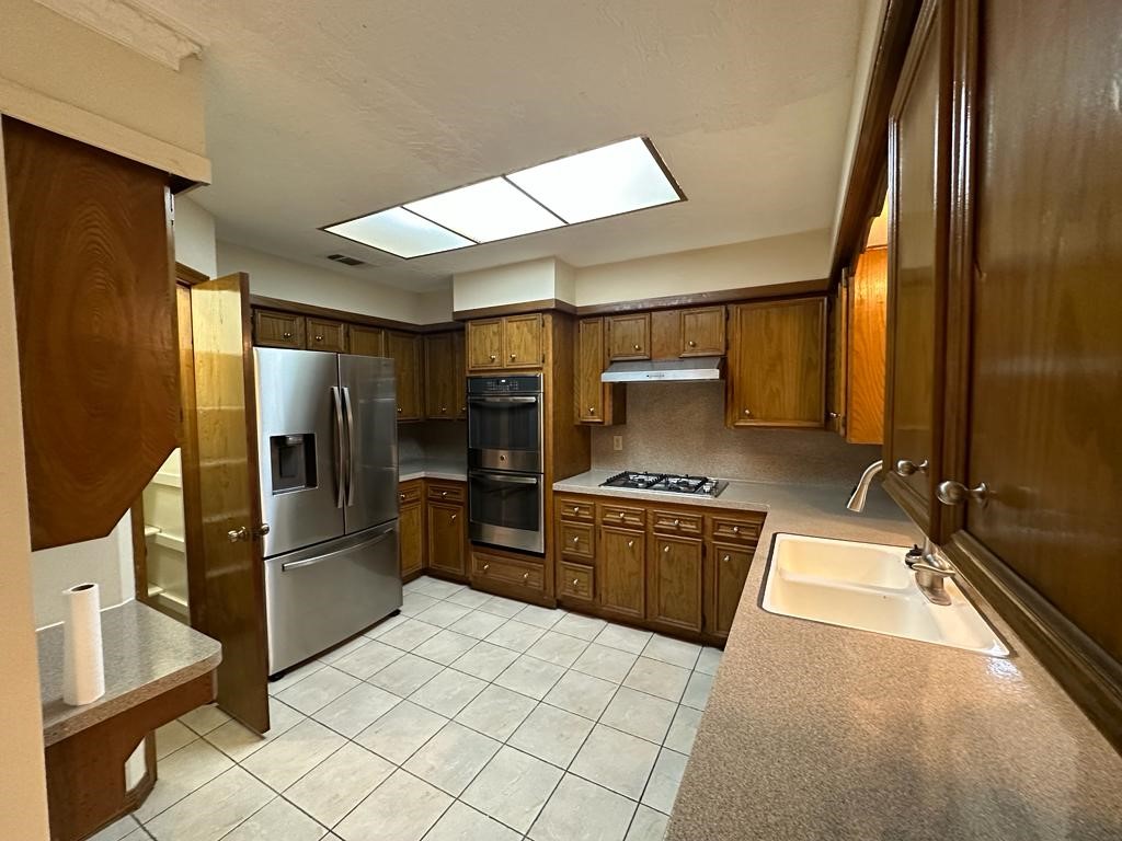 239 Kings Way Stafford, TX 77477 - Photo 7 of 24 a kitchen with stainless steel appliances granite countertop a refrigerator and a stove