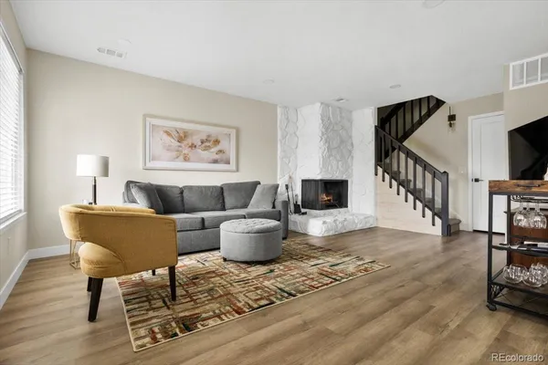 a living room with furniture a rug and a window