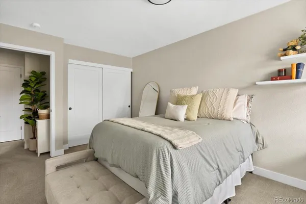 a bedroom with a bed and a potted plant