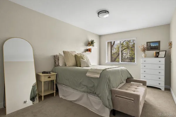 a bedroom with a bed and a couch