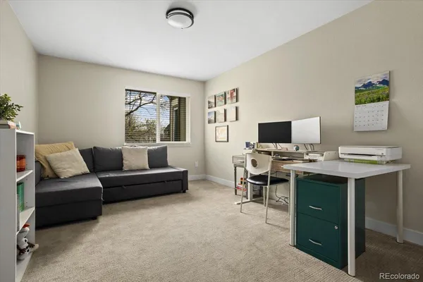a view of a livingroom with workspace and a couch