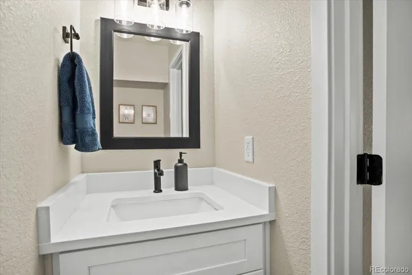 a bathroom with a sink vanity and a mirror