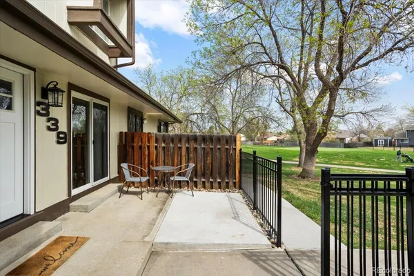 a view of balcony with chairs and wooden fence