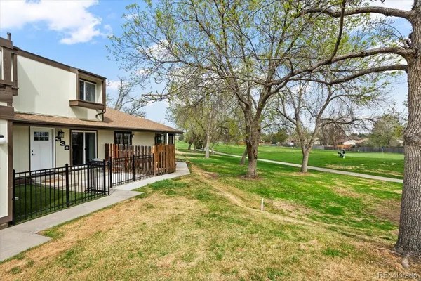 a view of house with backyard and trees