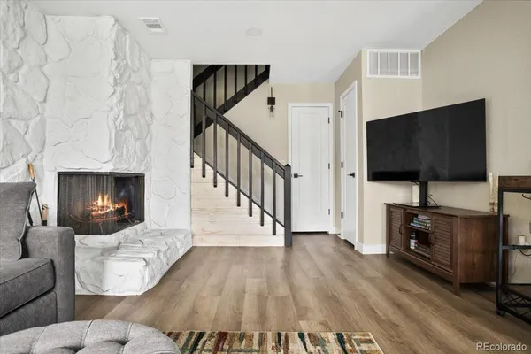 a living room with furniture fireplace and flat screen tv