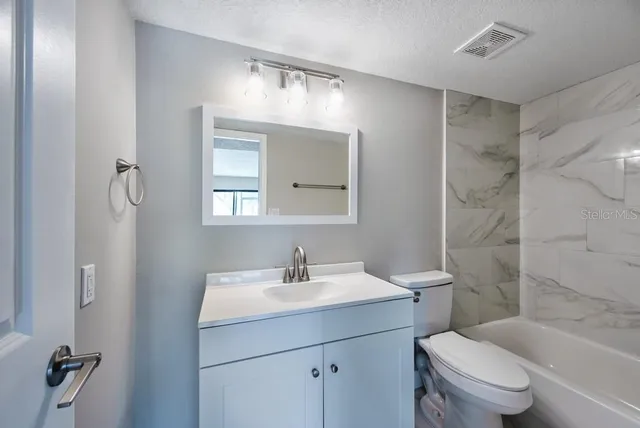a bathroom with a toilet sink shower and mirror