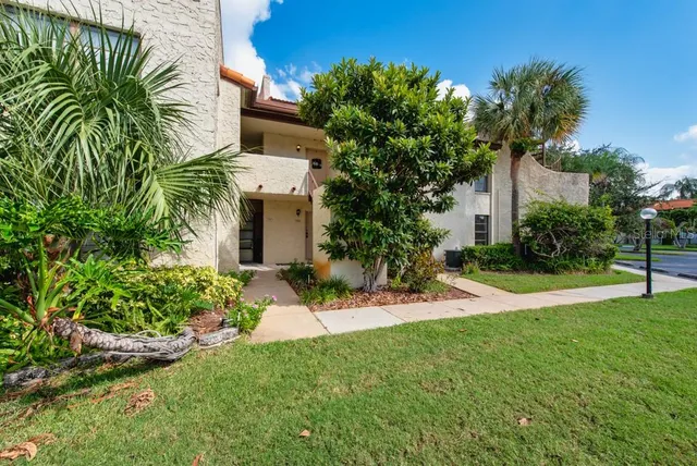 a view of a house with a yard and plants