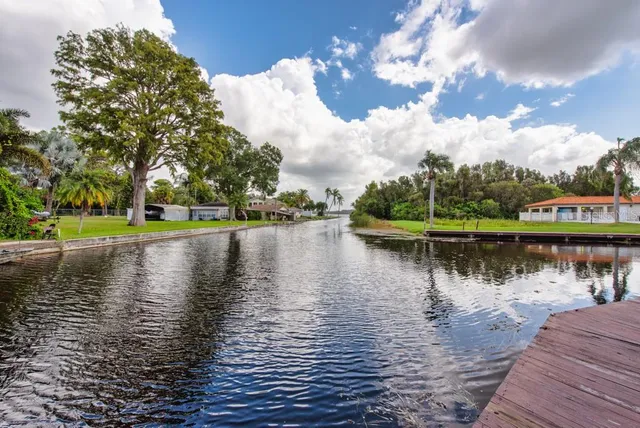 an aerial view of a house with a garden and lake view