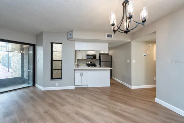 a view of a kitchen with a sink and dishwasher wooden floor