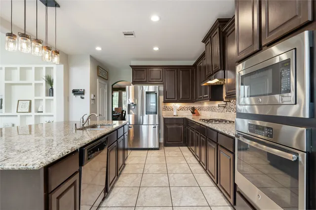 a living room with a kitchen island furniture and a kitchen view