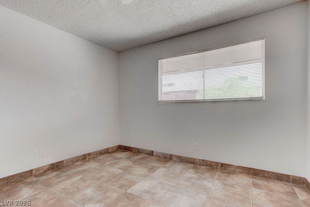 421 North Decatur Boulevard, Unit 2 Las Vegas, NV 89107 - Photo 21 of 21 A well-lit room featuring durable tile flooring and a bright window.