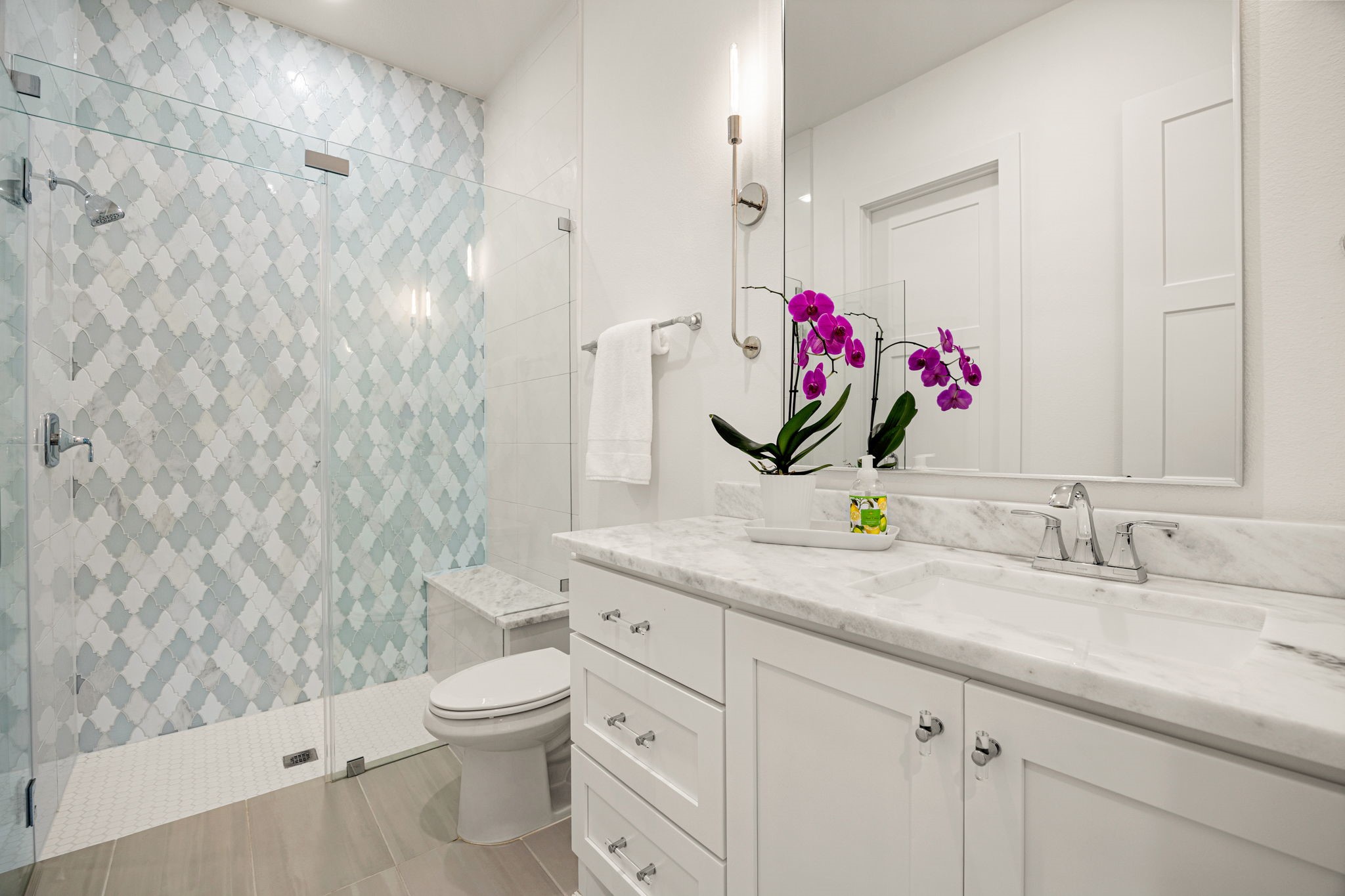 27903 Indigo Ridge Drive Fulshear, TX 77441 - Photo 26 of 50 Stylish secondary bathroom featuring a walk-in glass shower, designer tile accents, and elegant finishes.