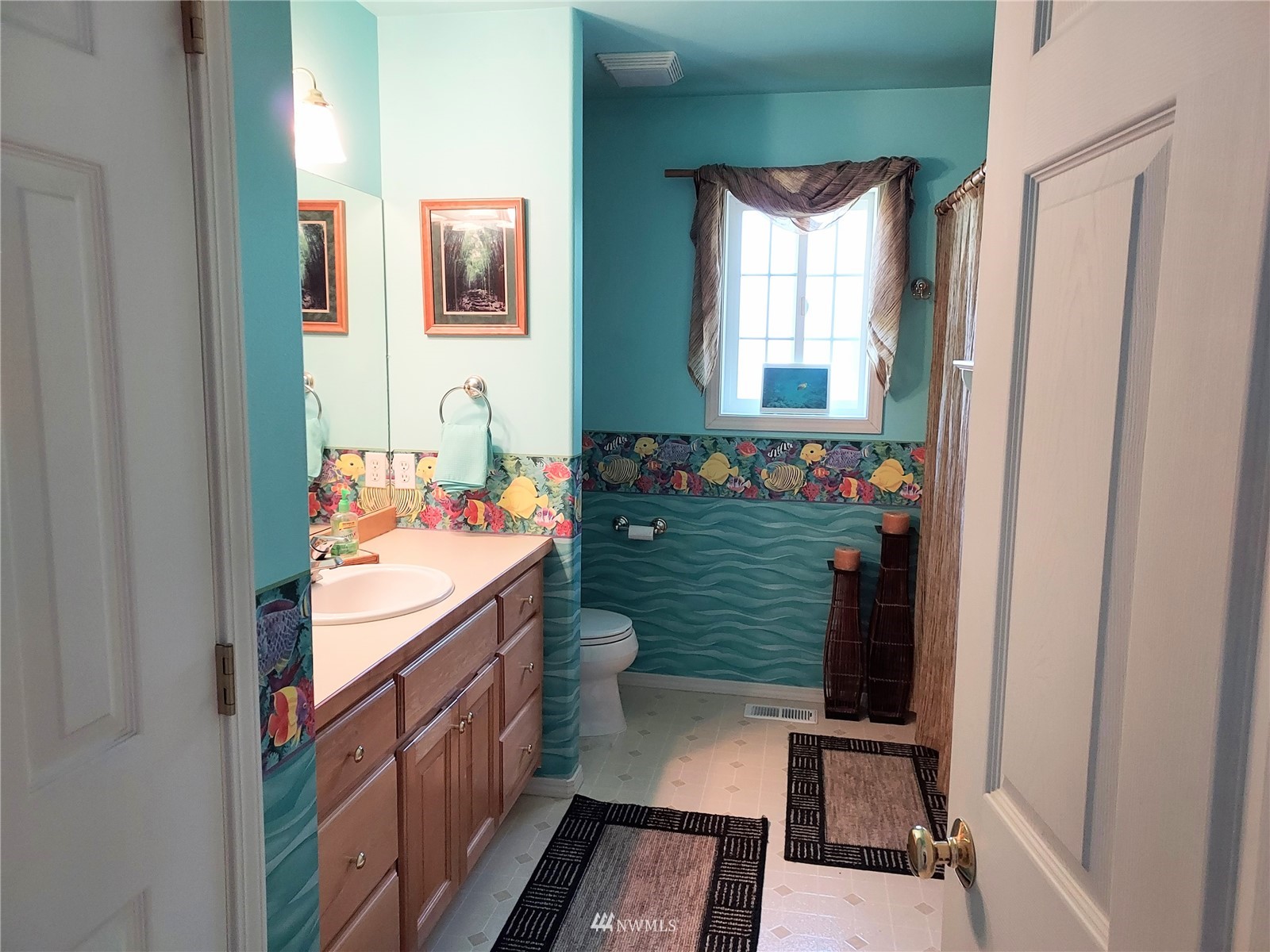 150 Donaper Road Sequim, WA 98382 - Photo 17 of 25 a bathroom with a sink a mirror and a bathtub
