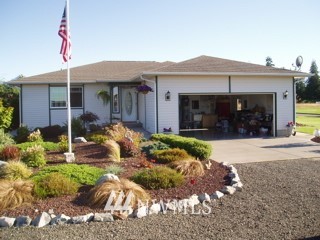 150 Donaper Road Sequim, WA 98382 - Photo 23 of 25 a front view of a house with garden