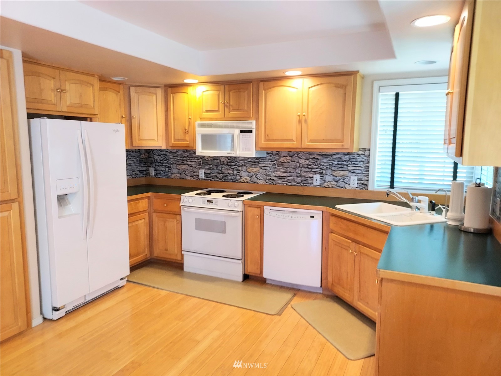 150 Donaper Road Sequim, WA 98382 - Photo 8 of 25 a kitchen with stainless steel appliances granite countertop a sink stove and refrigerator