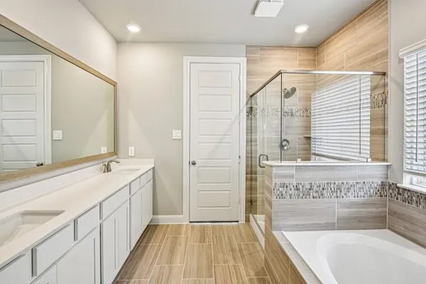 a bathroom with a sink double vanity and a mirror