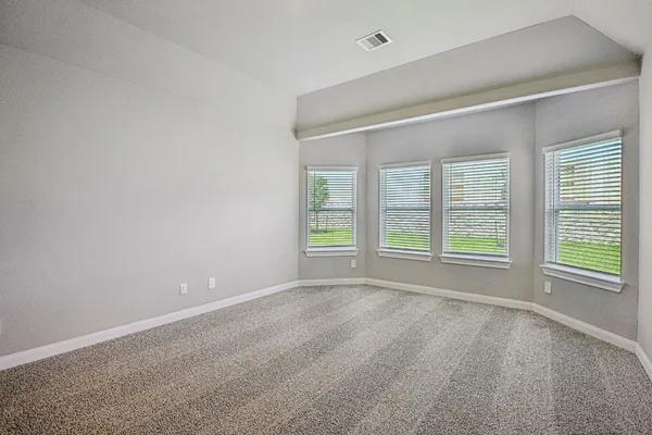 an empty room with windows and entrance