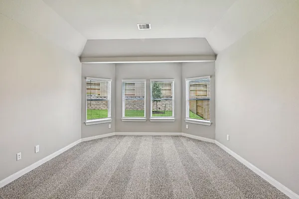 a spacious bedroom with a large bed and a couch