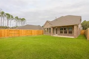 a front view of a house with a garden and lake view
