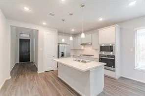 a kitchen with a stove a sink and a refrigerator