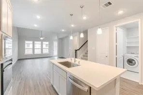 a view of a kitchen with a sink and wooden floor