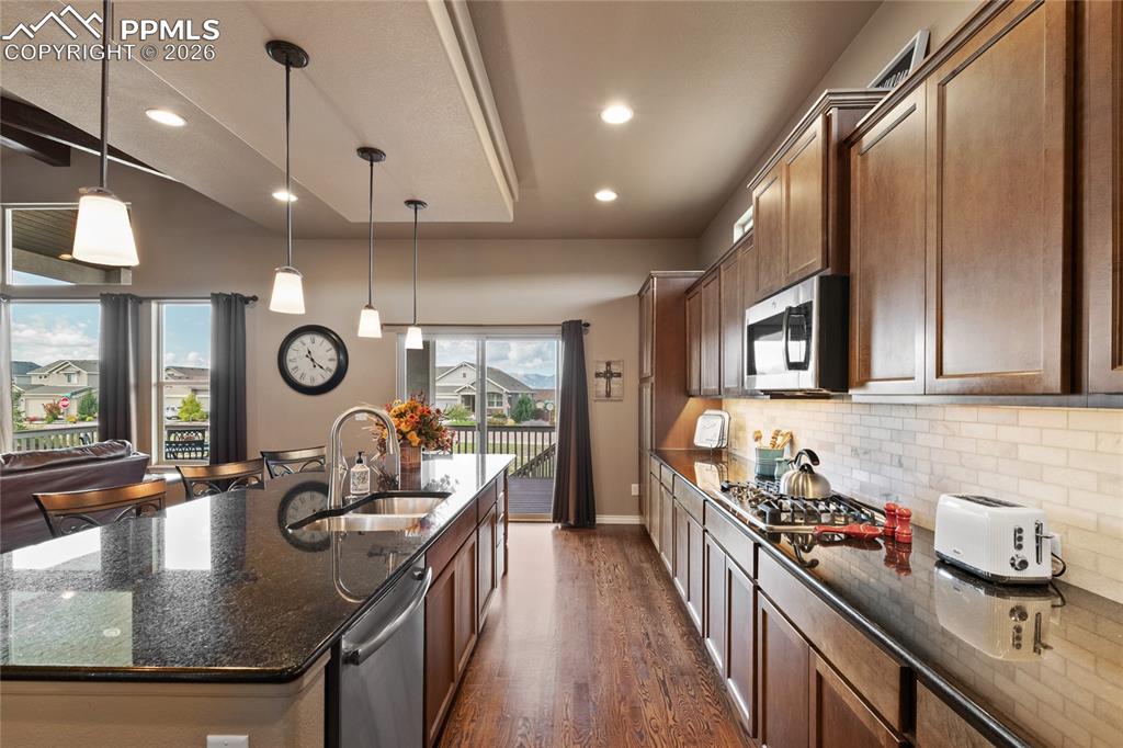 3718 Sky Rim Court Colorado Springs, CO 80908 - Photo 19 of 49 Granite countertops, gas cooktop and all stainless steel appliances. Hardwood floors.