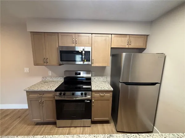 a kitchen with a refrigerator and a stove
